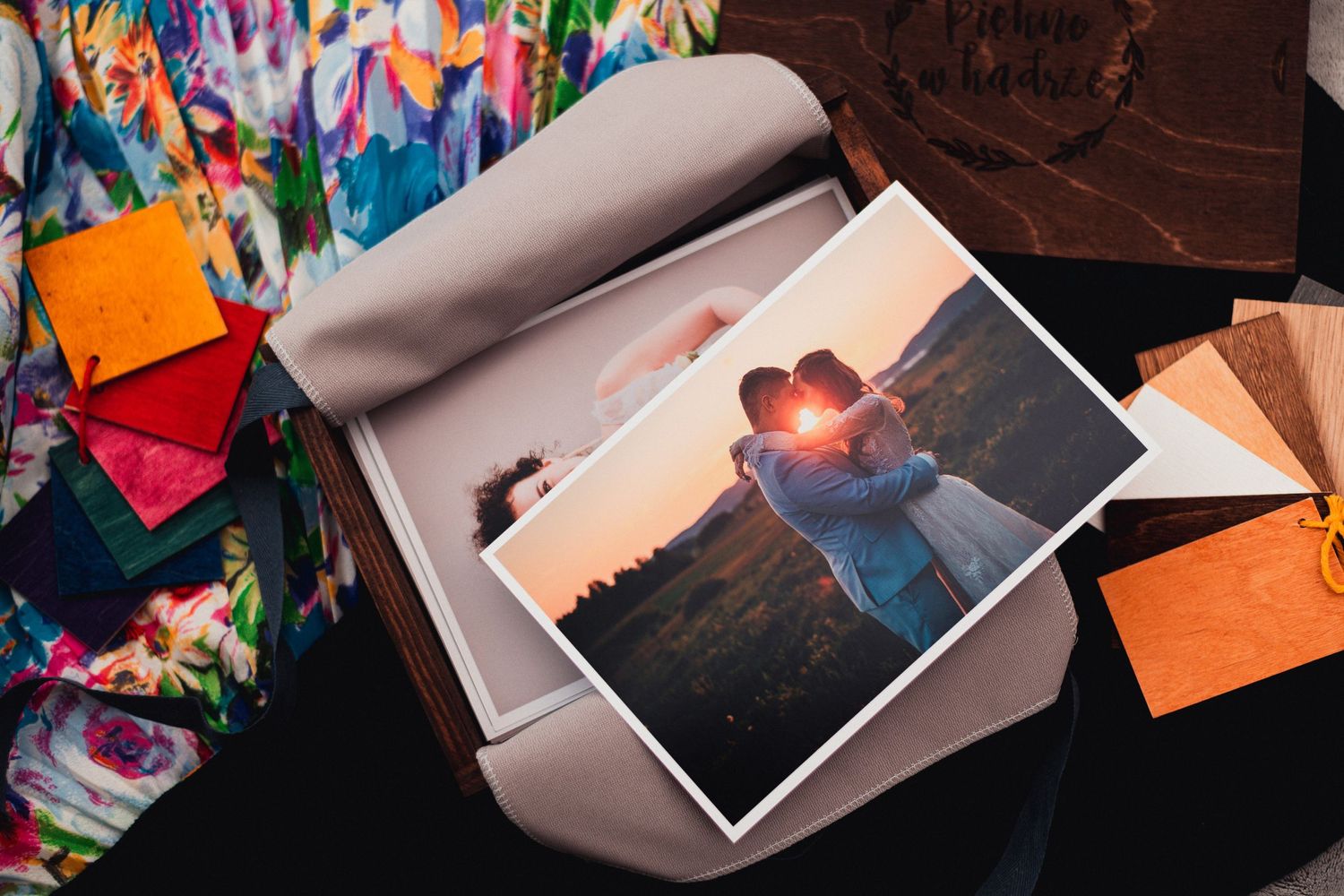 Colorful wedding photo albums and prints displayed against vibrant graffiti background.
