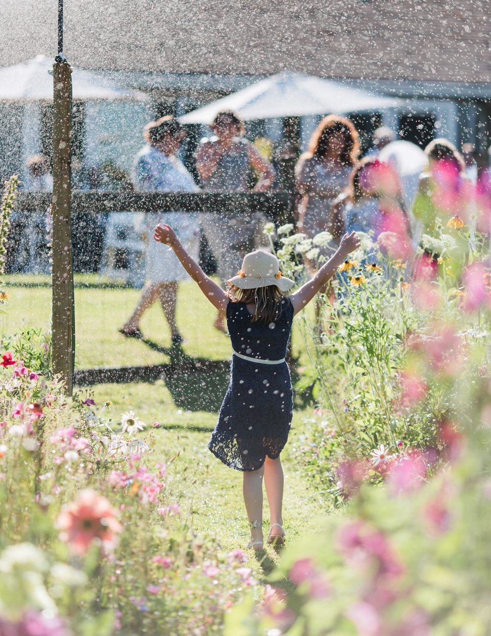 A joyful wedding guest cools off from the hot summer sun