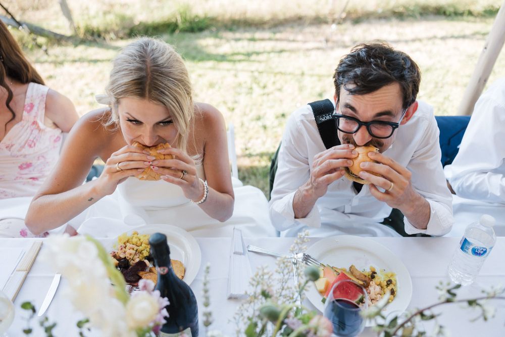 Emery and Matt eat burgers at their wedding in Victoria, B.C.