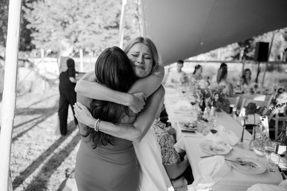 The bride hugs an old friend