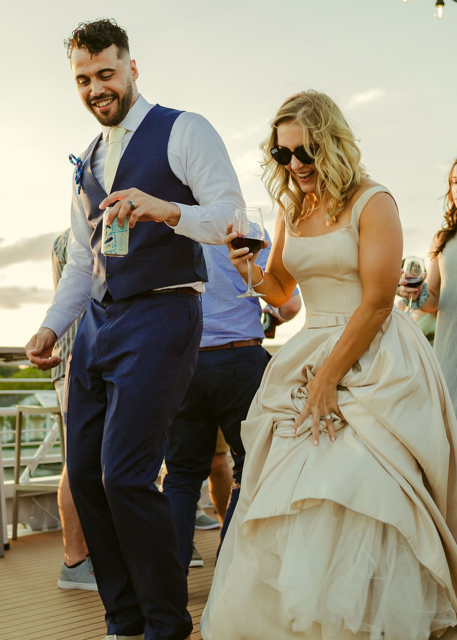 bride and groom dancing with drink at hand