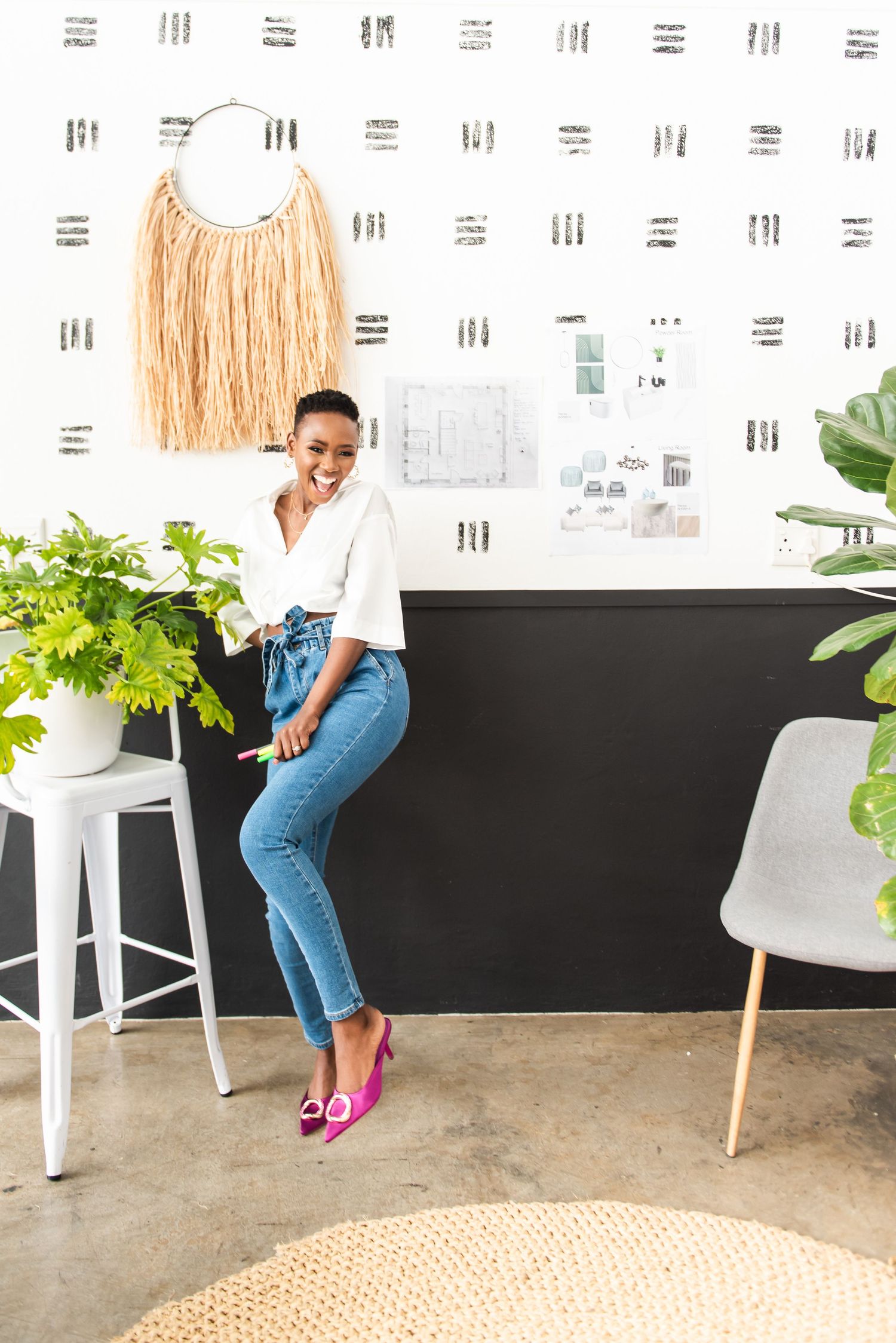 Bright workspace featuring woven wall art and contemporary furniture with natural lighting.