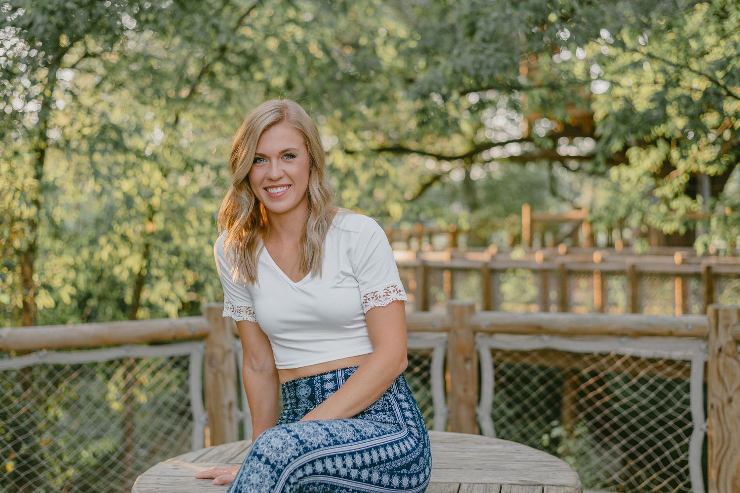 headshot of a woman smiling in a treehouse park