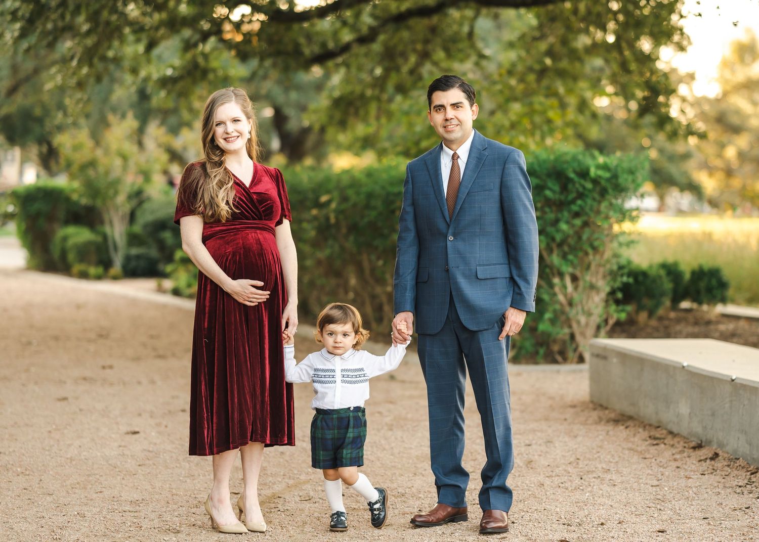 Family walking together during autumn outdoor photo session.