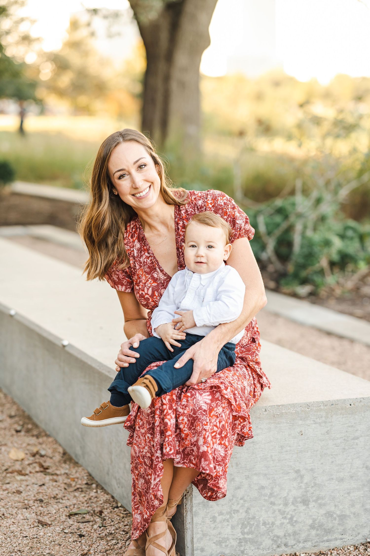 Casual family portraits on concrete ledge during golden hour photoshoot.