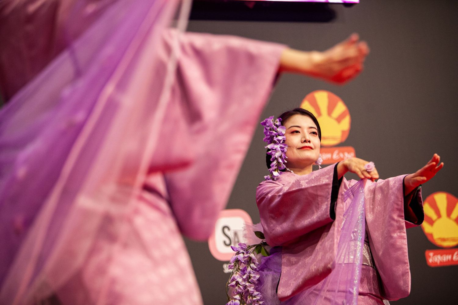 Graceful dance performance with flowing purple fabric and traditional Japanese costume.