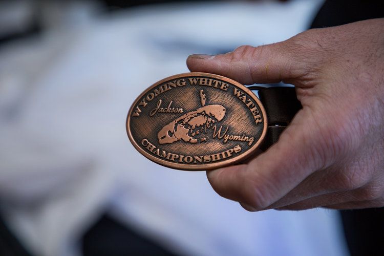 Close-up shot of a bronze medal being held by a hand.