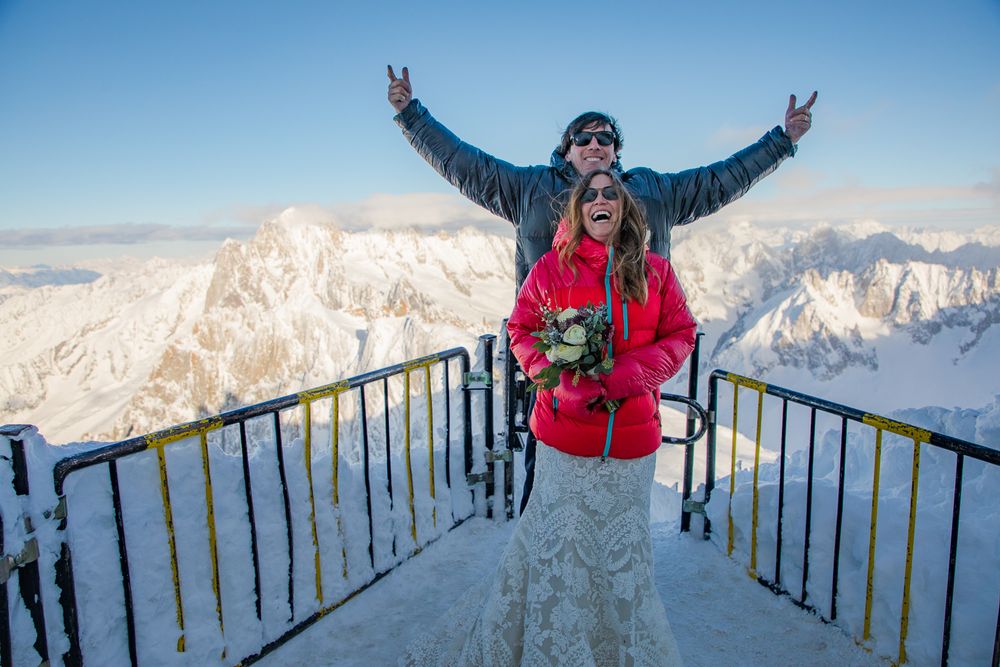 Snow-covered mountain observation deck with visitors enjoying panoramic Alpine views.