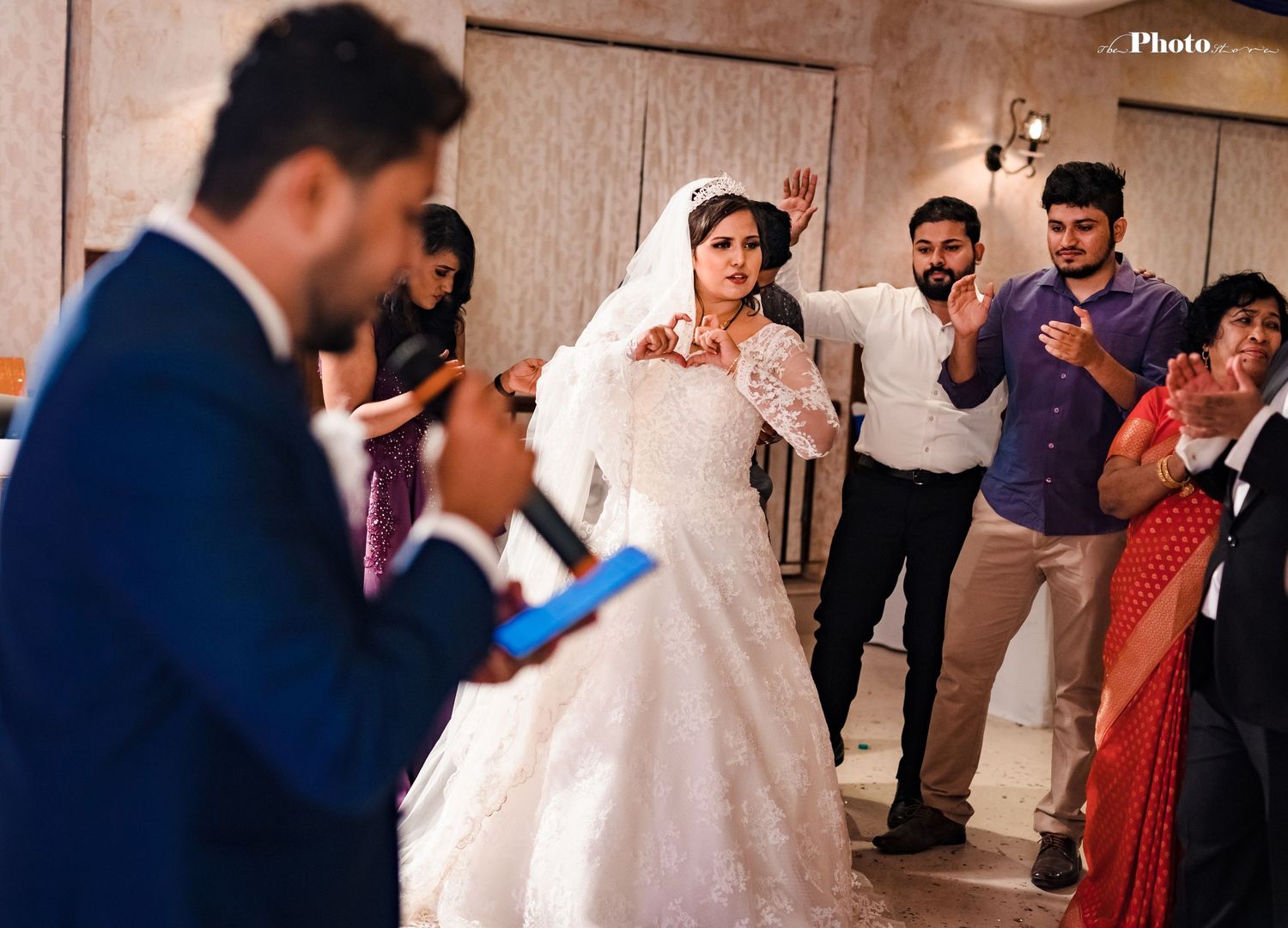 Wedding reception entertainment with bride and guests enjoying musical performance.