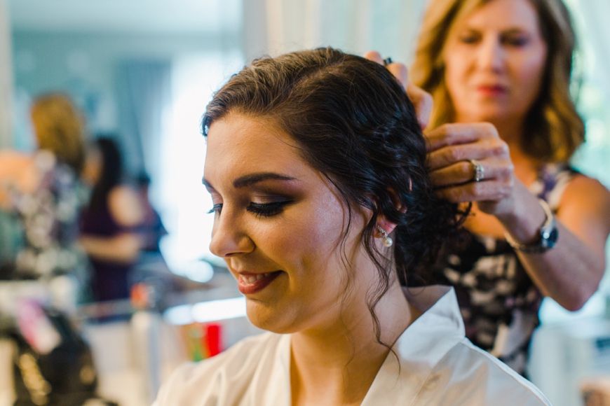 Getting ready scene with someone having their hair styled for a special occasion.