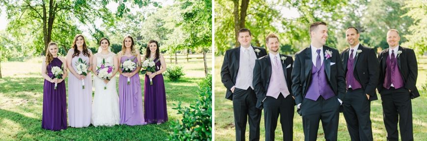 Wedding party poses outdoors with bridesmaids in purple dresses and groomsmen in black suits with purple accents.