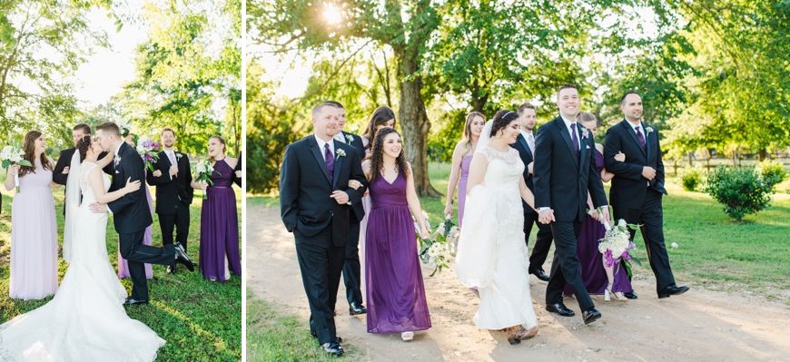 Wedding party walks together on outdoor path with purple and black attire.