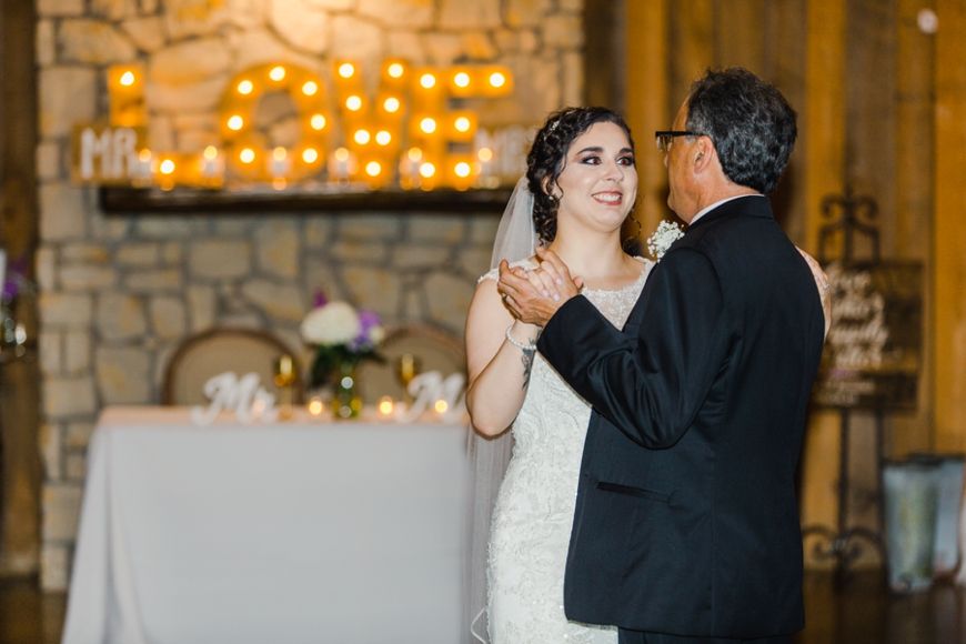 A bride and her dance partner share a special moment during a wedding reception.