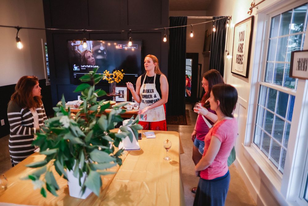 Art gallery interior with string lights and artwork displayed on walls.