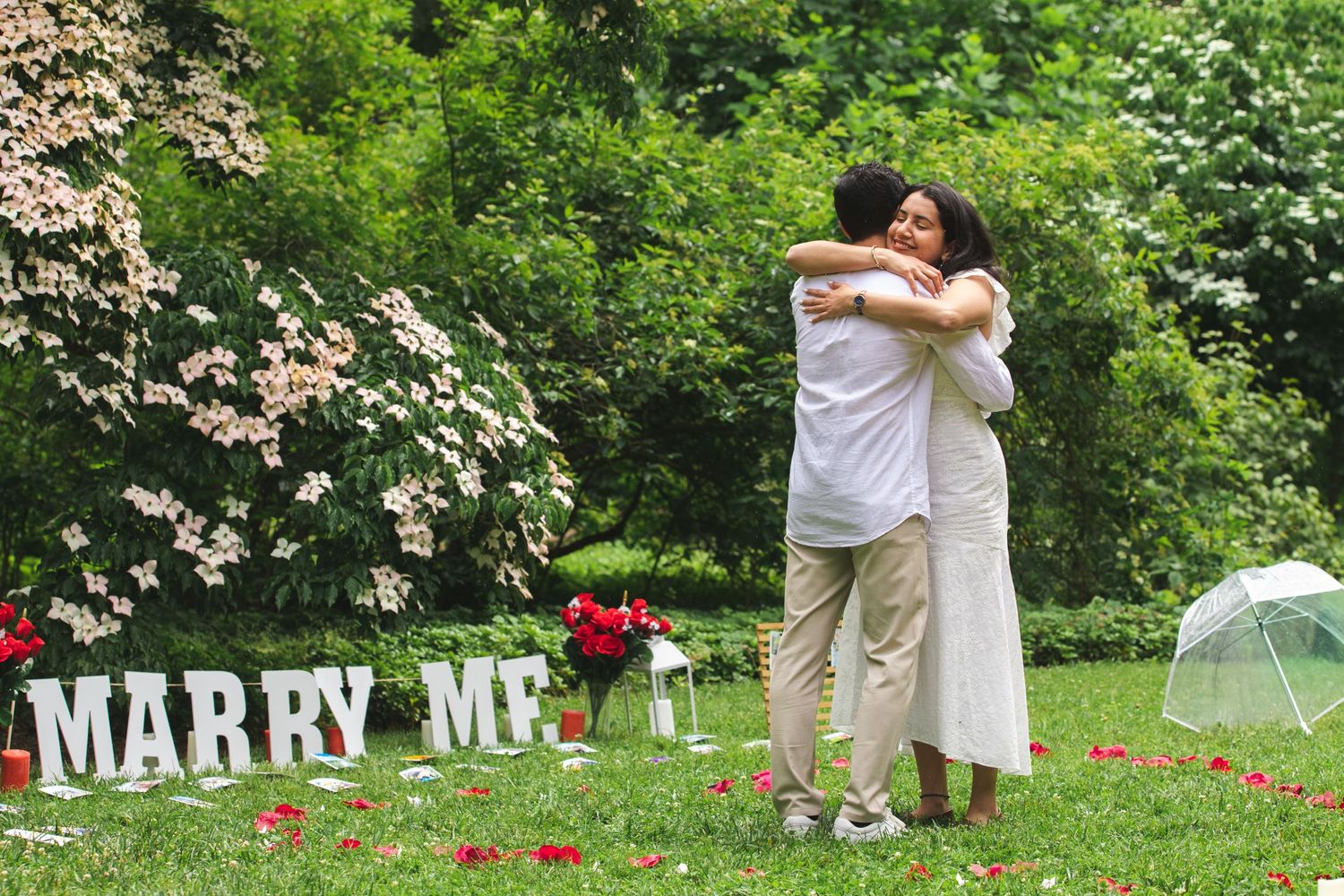 Couple embracing at surprise proposal in DC's Arboretum Dogwood Collections
