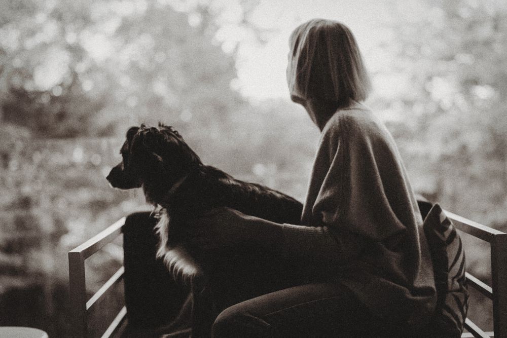 Silhouette of woman and her dog.