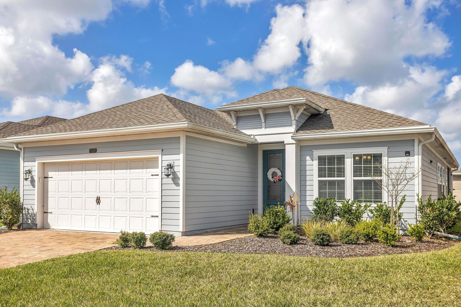 Front on house with clouds and blue sky