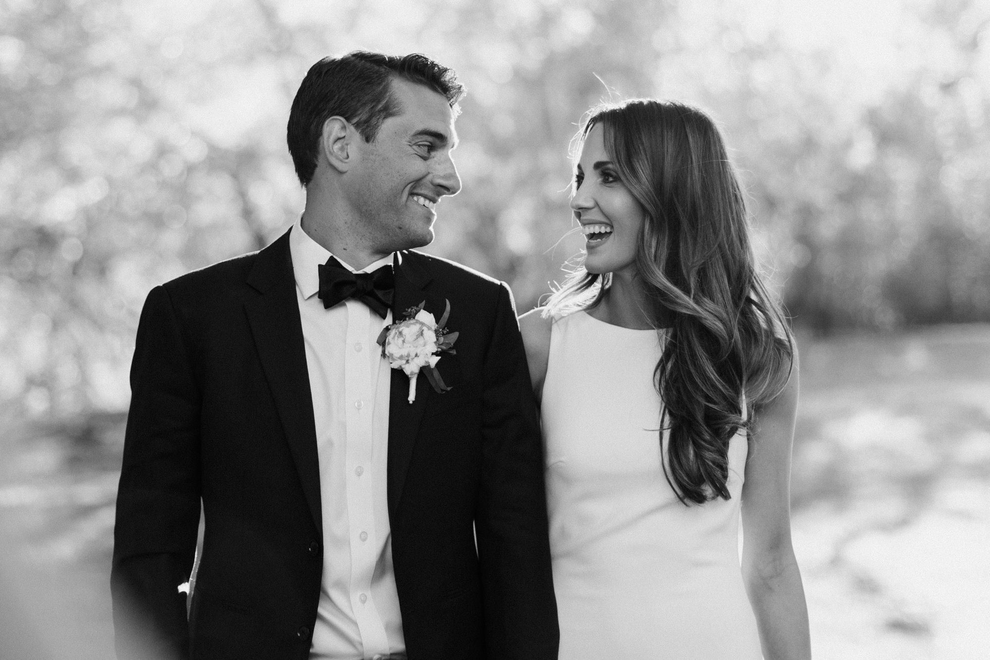 Black and white portraits show tender moments between newlyweds sharing joyful expressions.