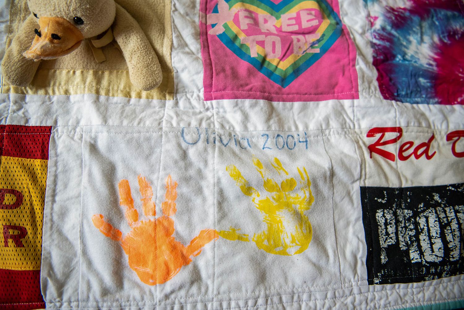 Hand prints painted onto fabric are incorporated into a memory quilt.