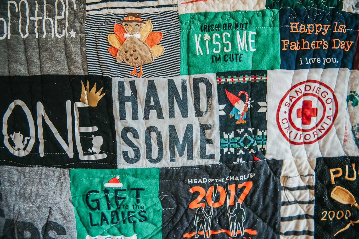 The word Handsome stands out in a patchwork memory quilt made with clothing.