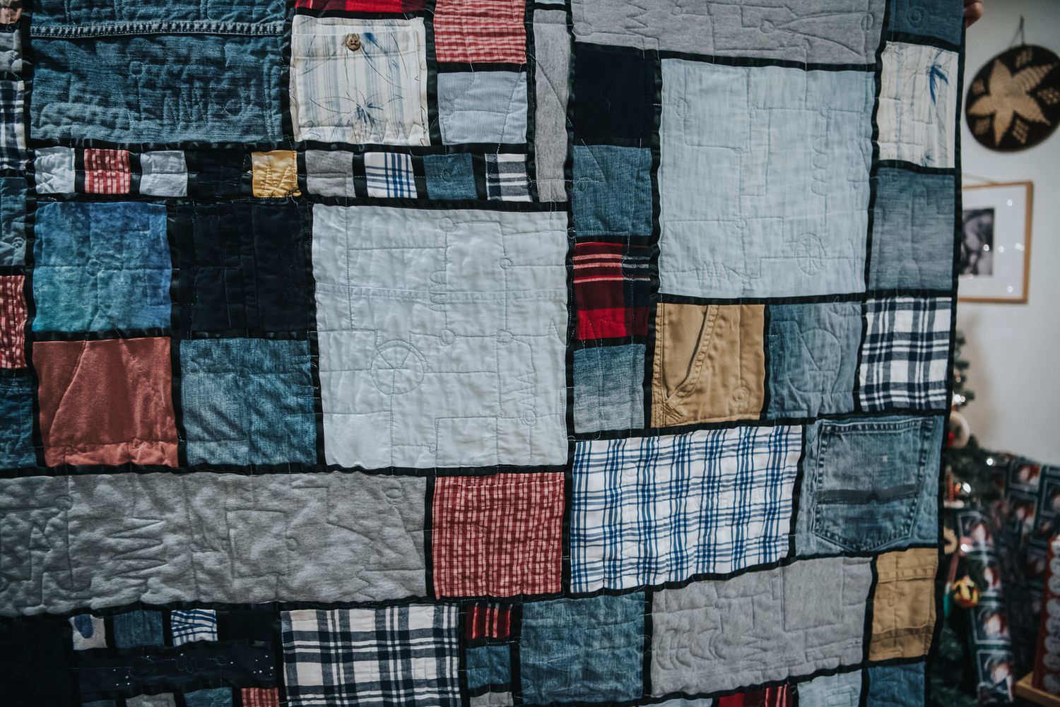 French window pane patchwork memory quilt made with black satin sashing.