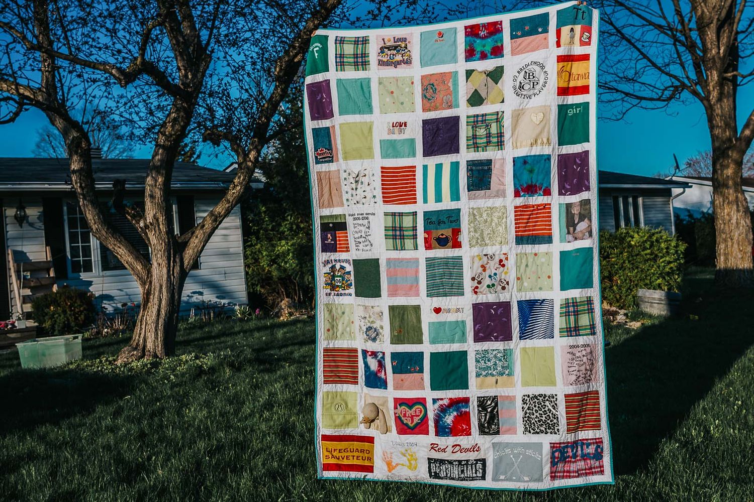 Large French window pane memory quilt filled with baby clothes.