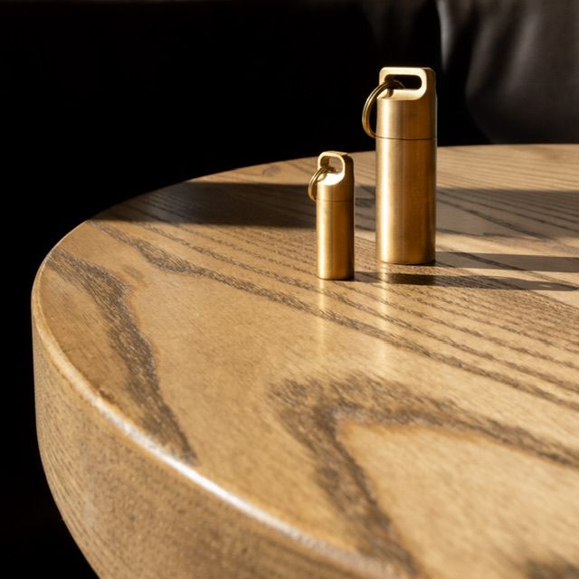Branded product photography, gold cosmetic bottles on wooden surface, North Vancouver brand photographer