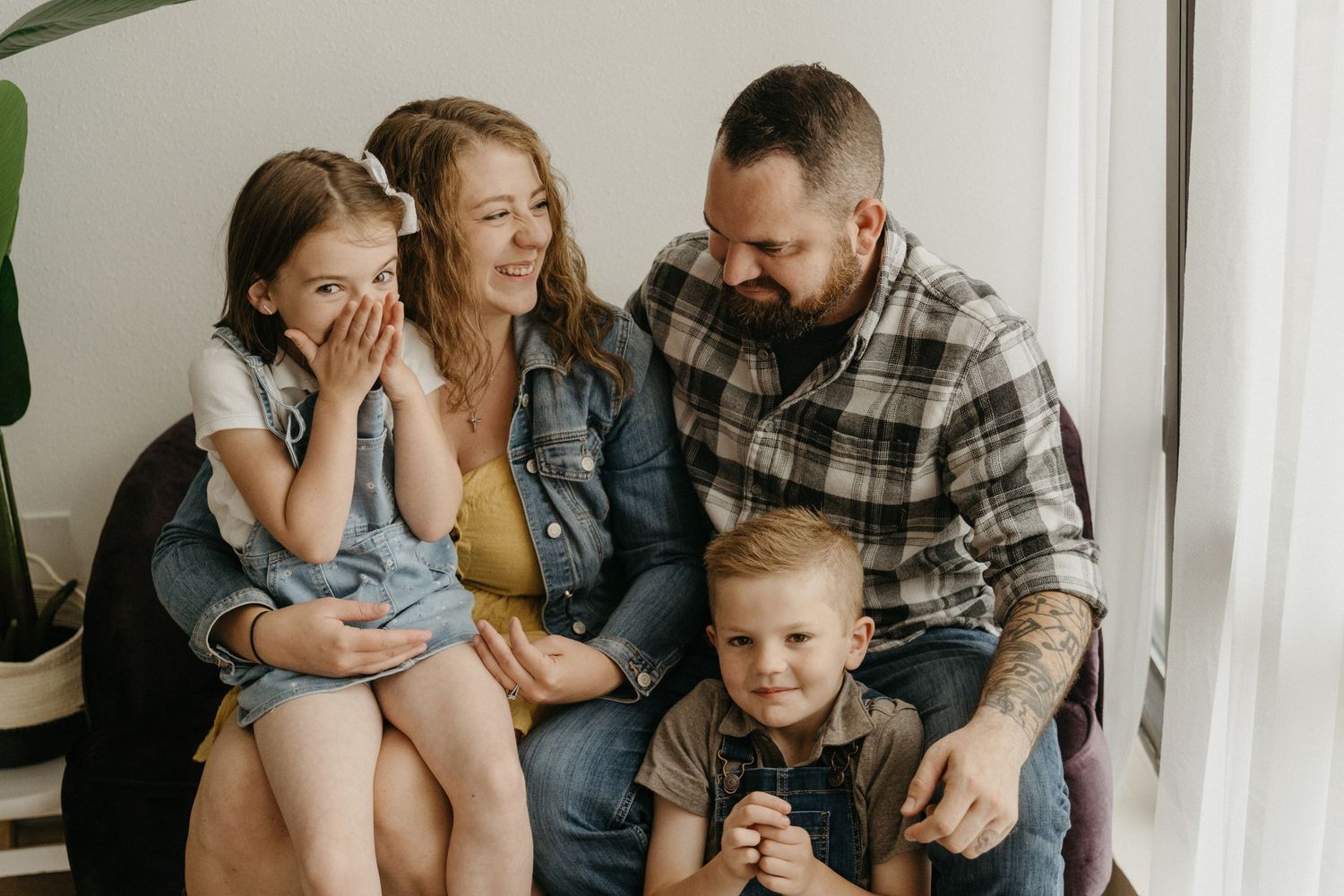 Family sharing a candid moment together on a couch at home.