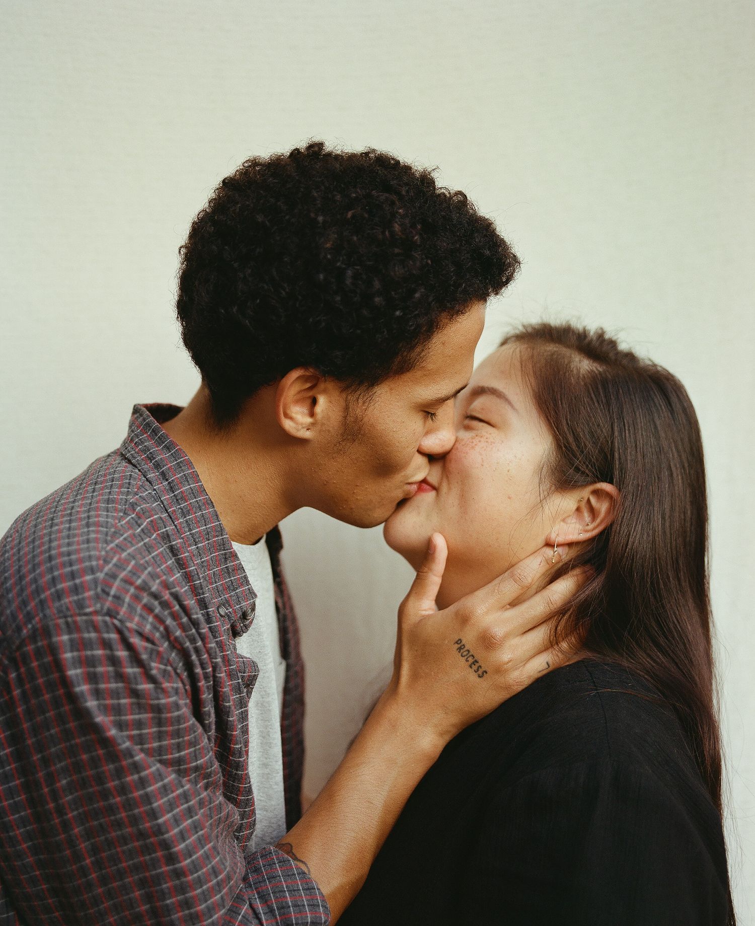 Sanetra Longno film photo of Elijah holding Michelle's neck and face while kissing her