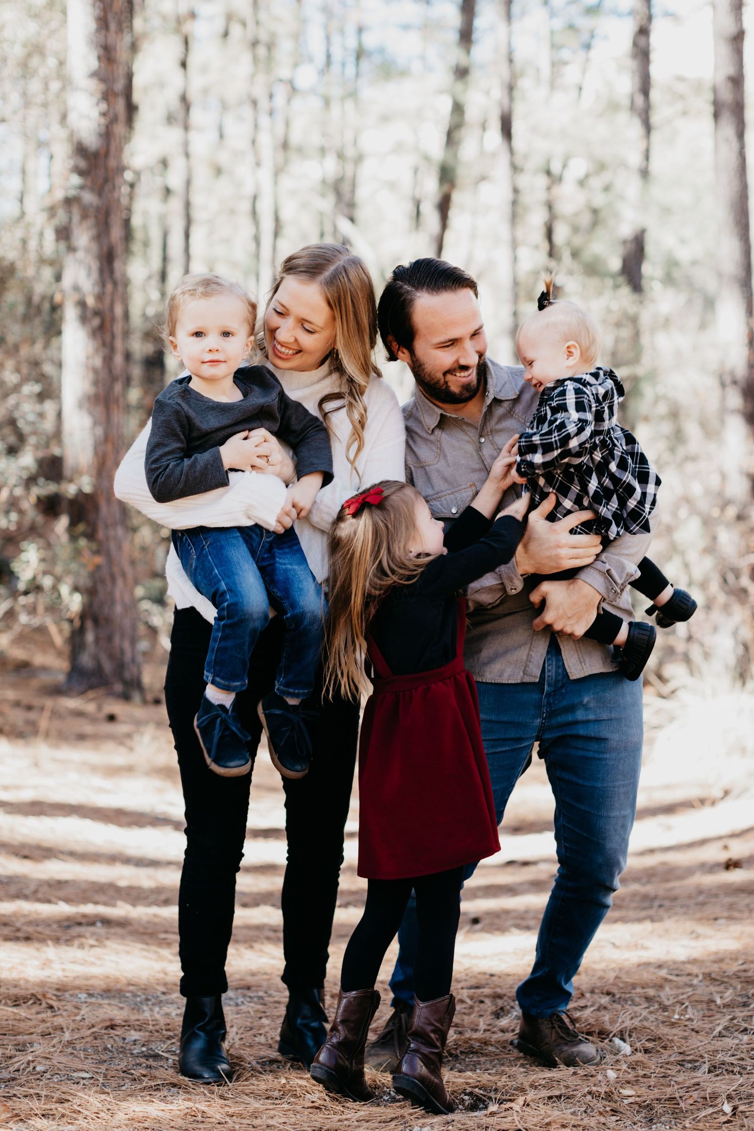 Tucson family portrait of parents walking with their children through a Mt. Lemmon area with natural, warm tones.