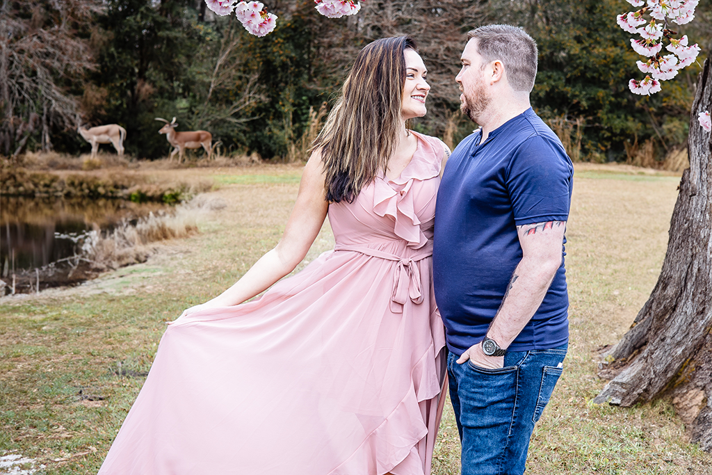 married couple, wild life photos, deer in the back ground