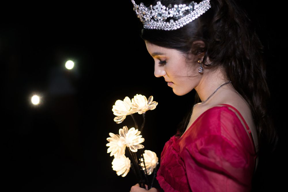 girl looking down to lit flowers. south padre island. Texas. Wedding photography