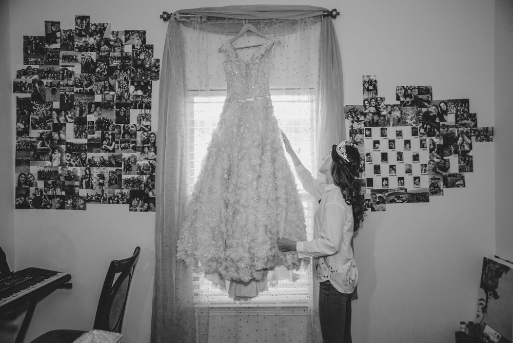 girl looking at her quinceanera dress. Verona Event Center. Pharr, Texas. Wedding photography