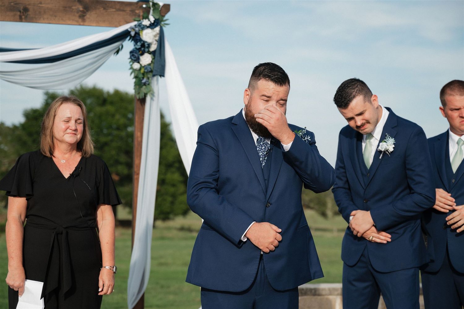 groom crying at altar of ceremony at Fannin Oaks wedding venue