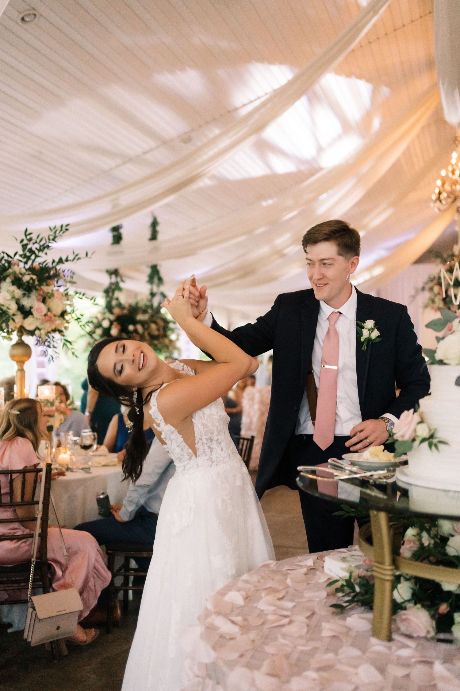 A joyful couple shares a fun cake-feeding moment during their wedding reception.