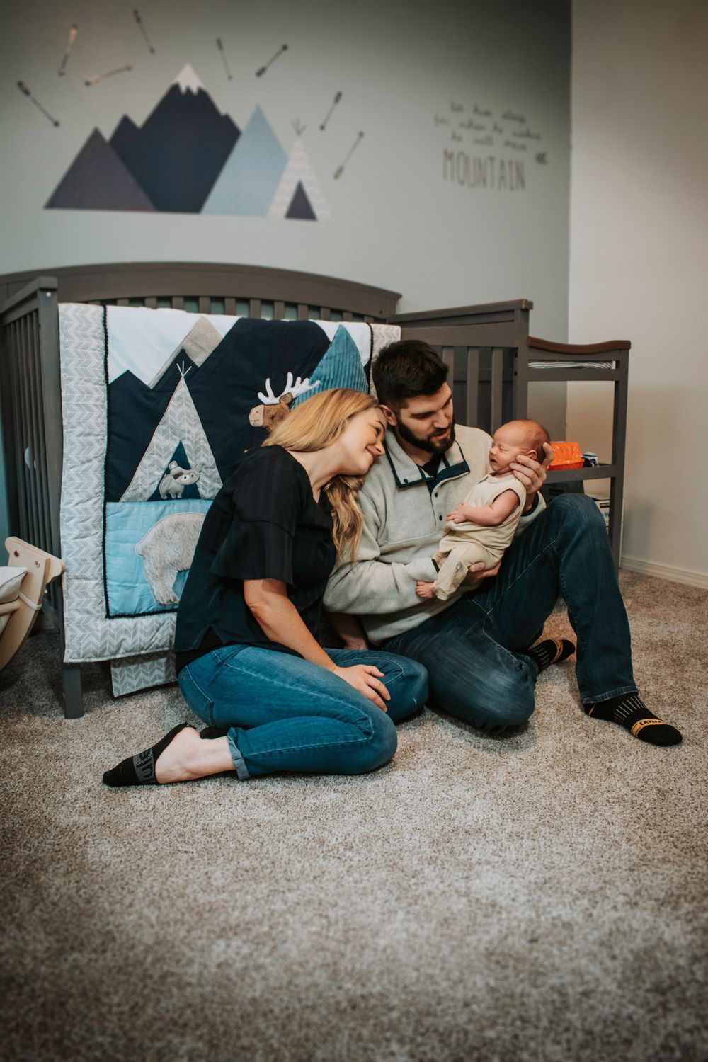 Parents by crib with baby