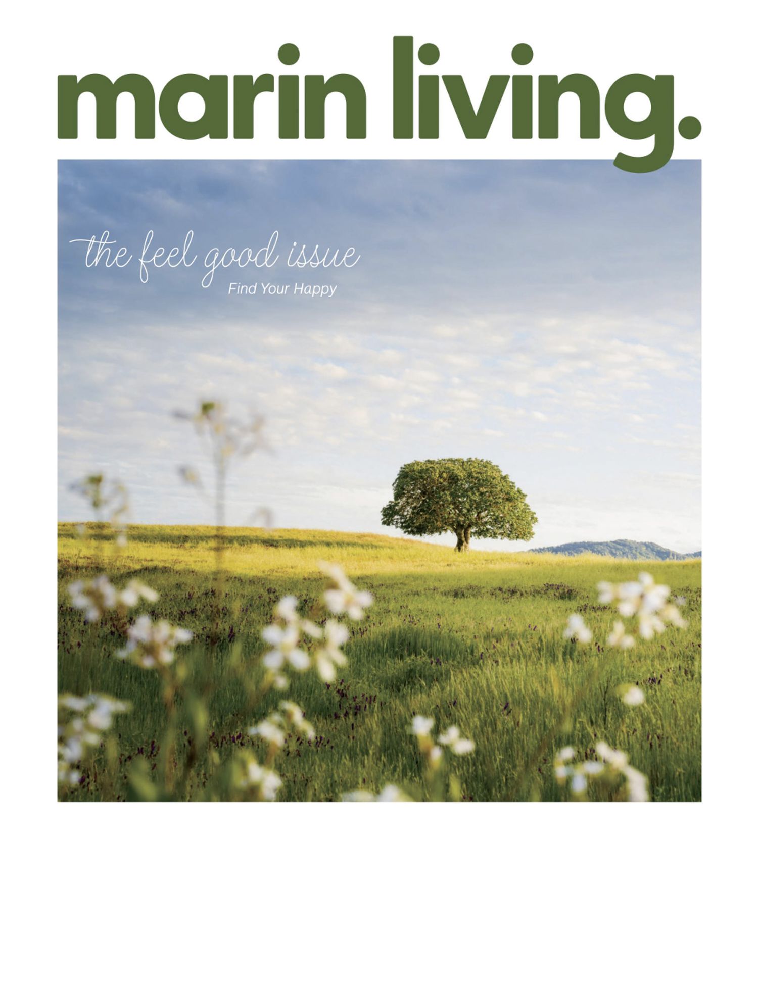 Magazine cover of Marin Living featuring a serene landscape with a lone oak tree on a grassy hillside against a blue sky.