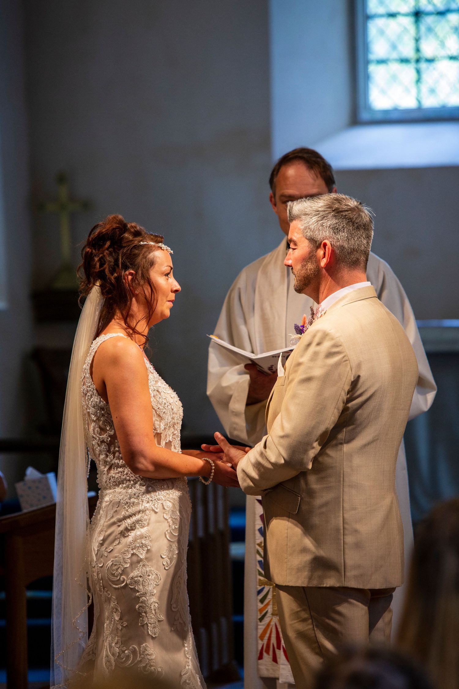 A couple shares an emotional first dance moment in a church during their wedding ceremony.