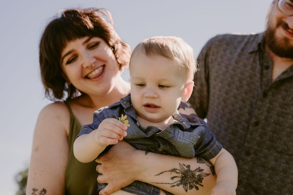 A candid moment of laughter and joy captured in bright summer sunlight.