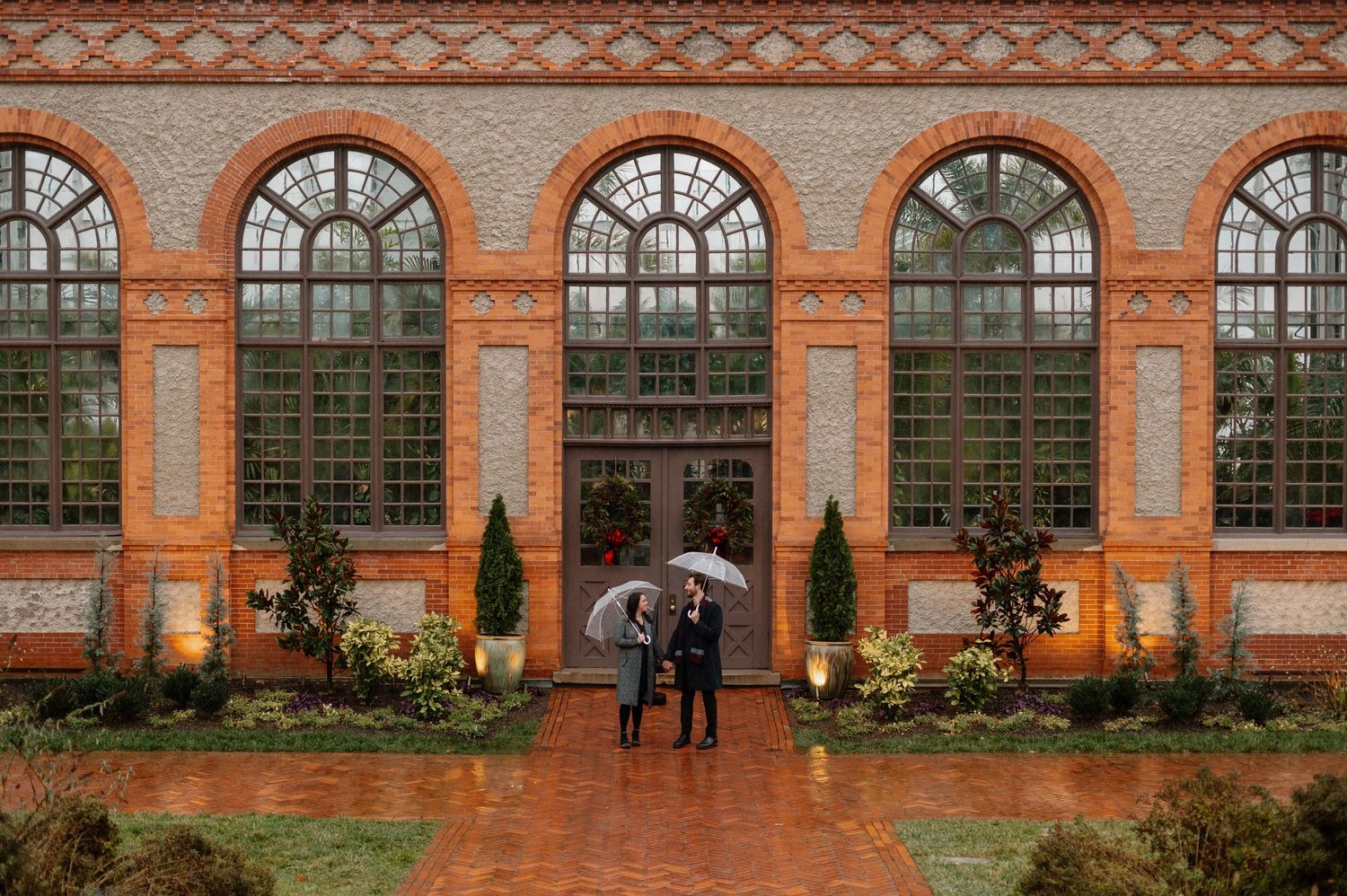 Couple holding hands at the Biltmore Conservatory in the rain