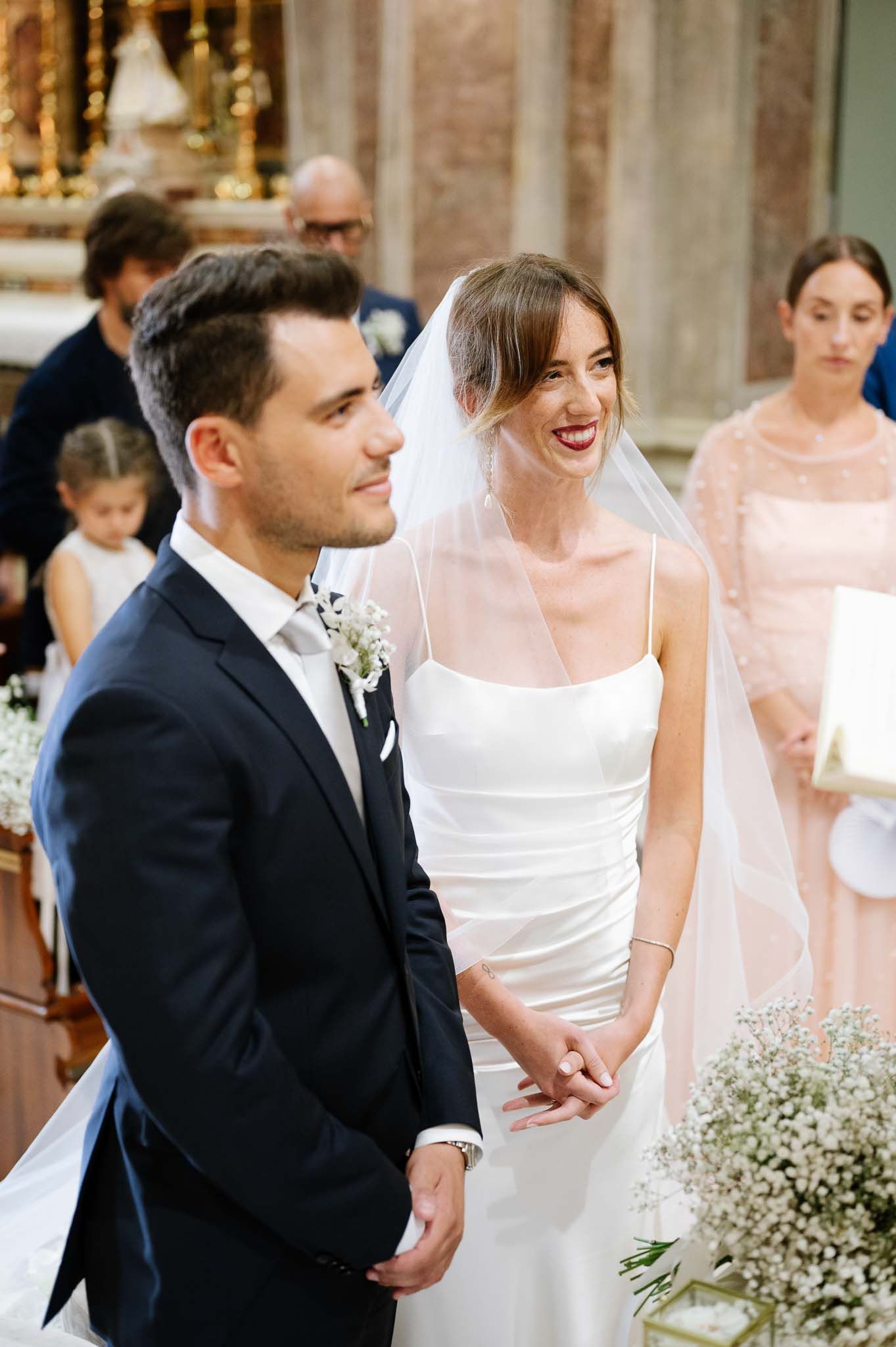 A joyful wedding ceremony moment captured in an elegant church with ornate details.