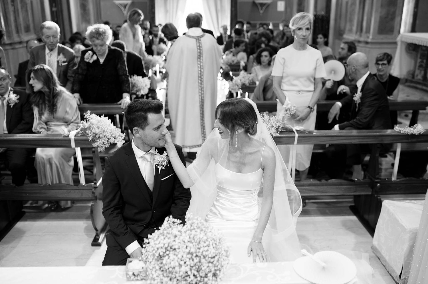 A tender black and white moment between a couple during their church wedding ceremony.