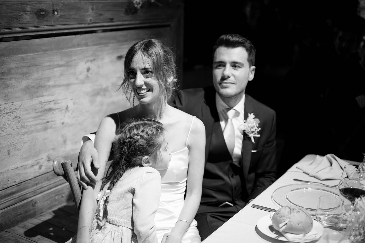 Newlyweds sharing a relaxed moment at their reception table.