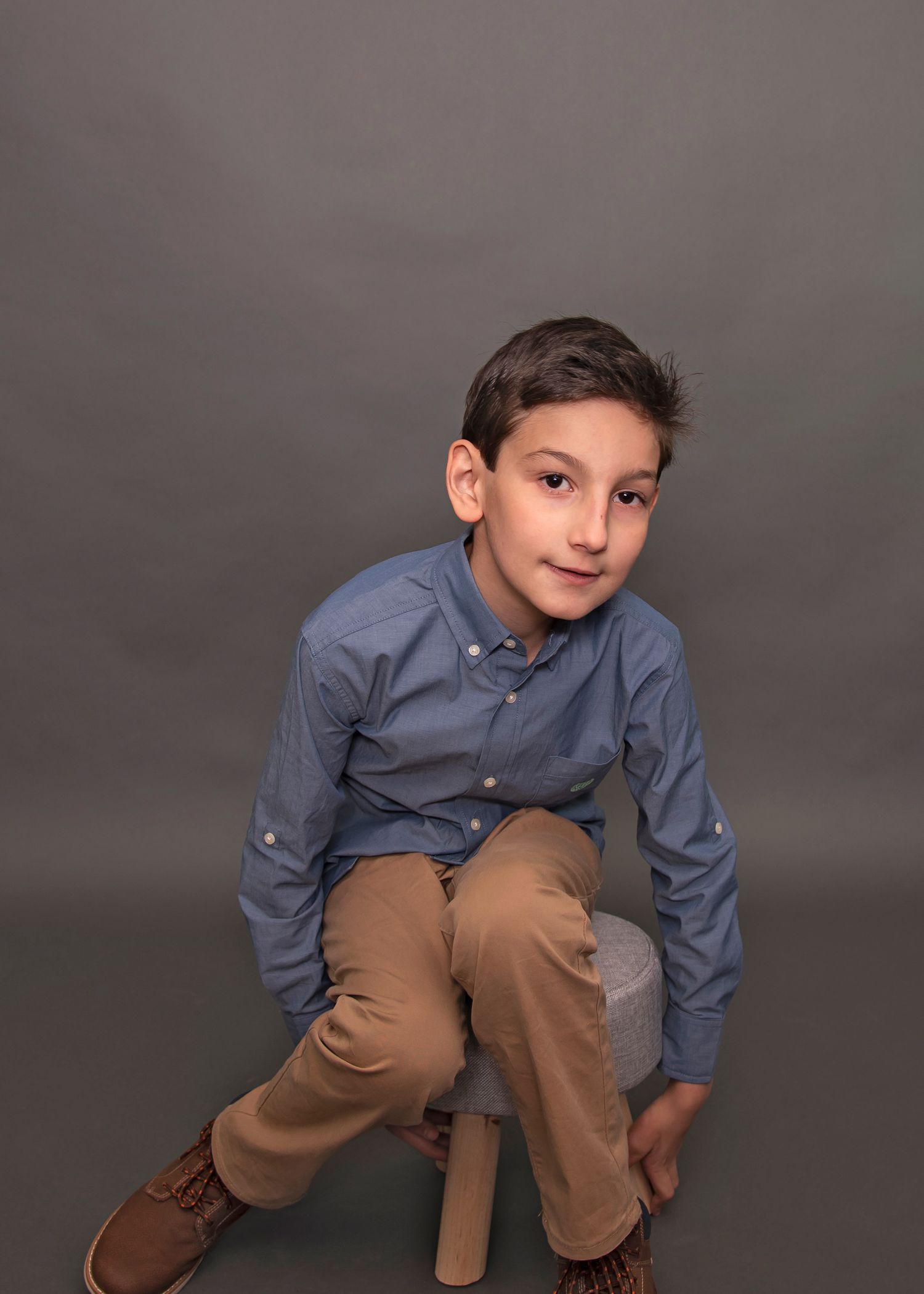 A formal studio portrait with lighting and backdrop.