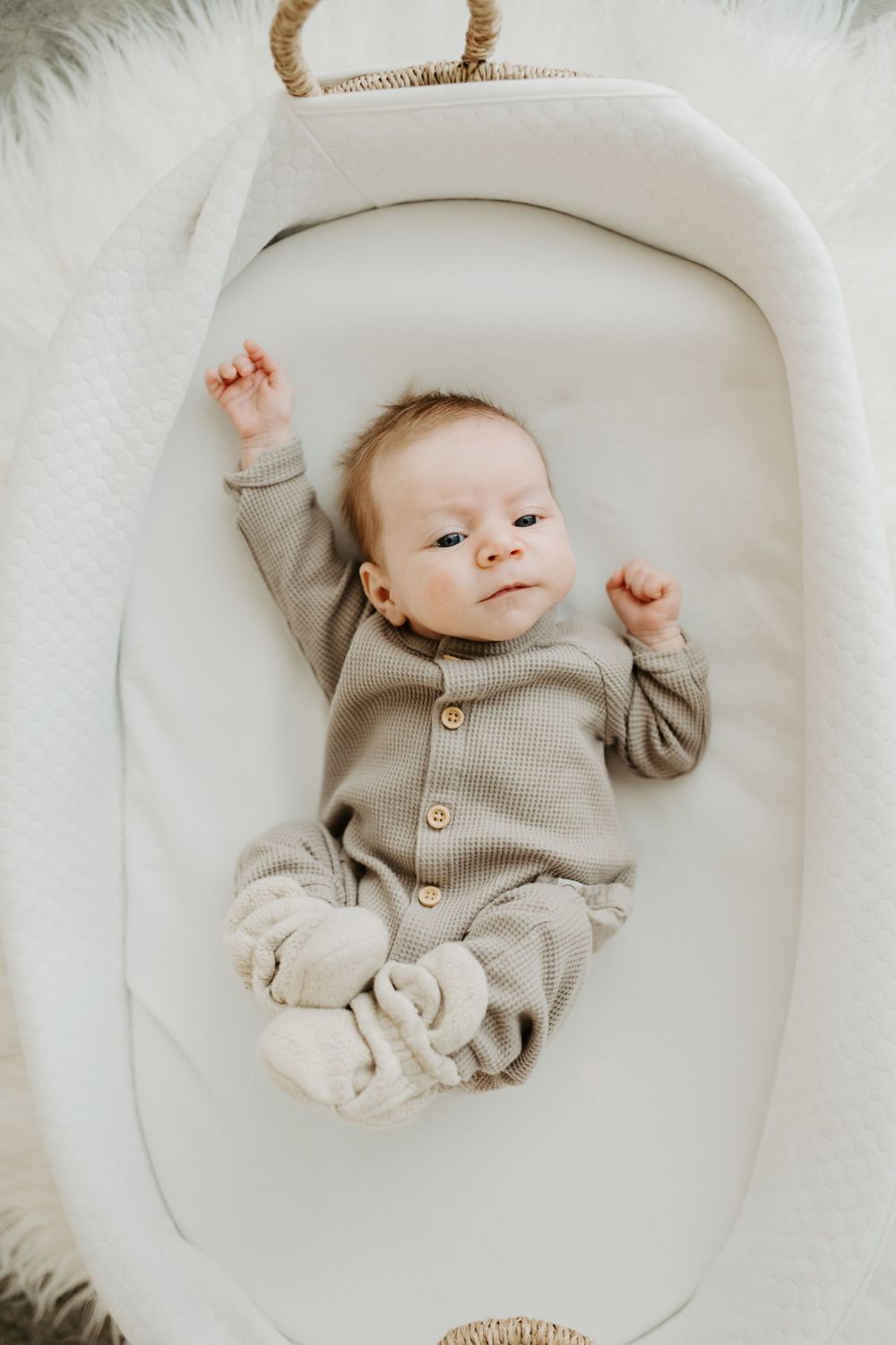 A baby in a bassinet during their lifestyle newborn session in Colorado
