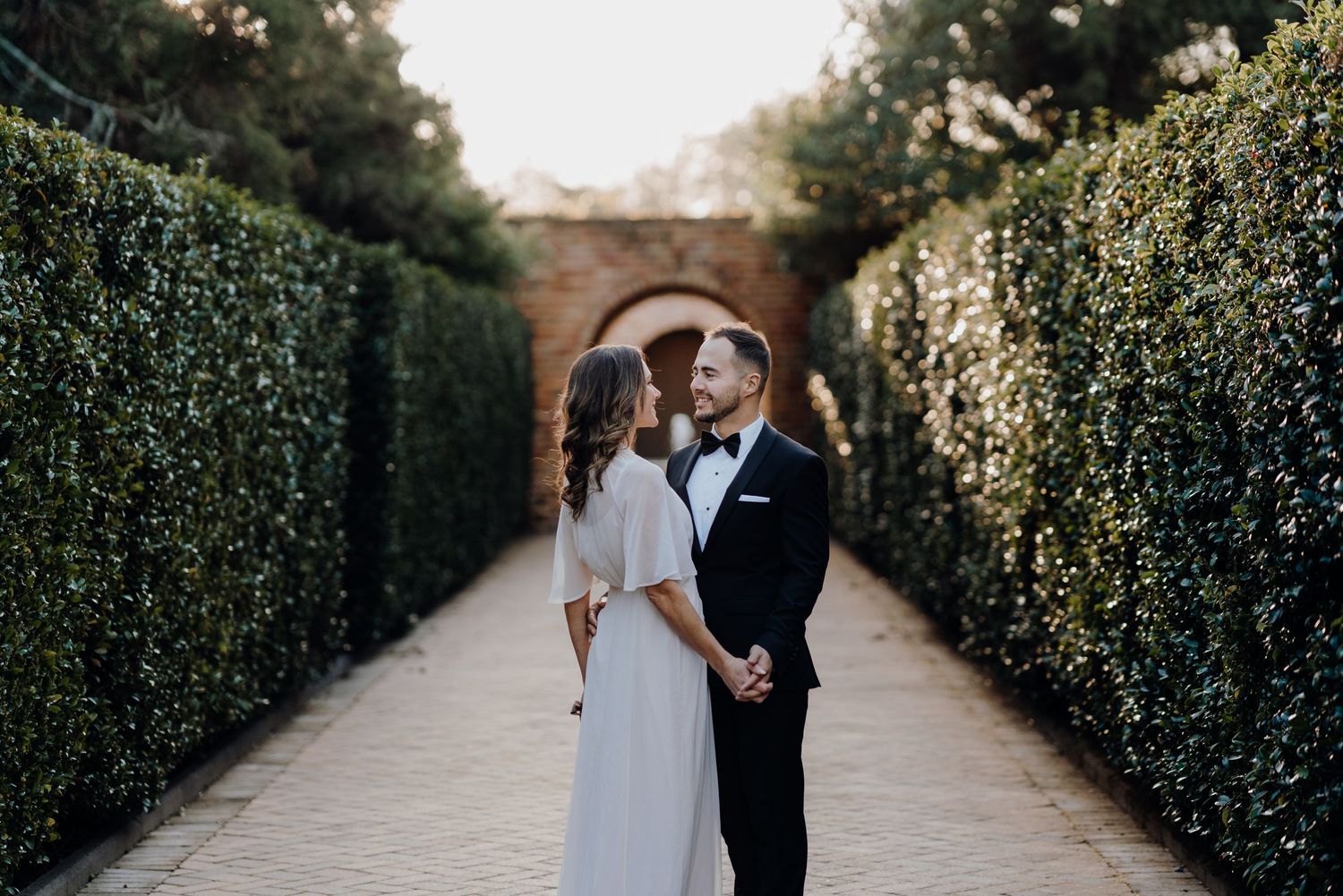 Bride and groom holding hands and smiling