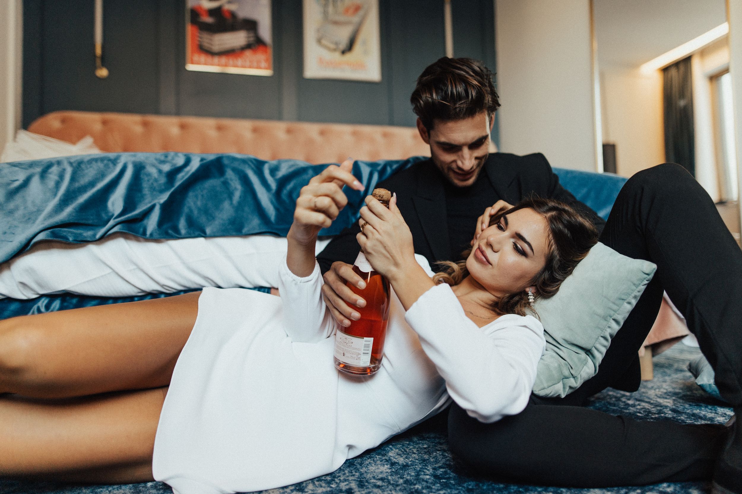 Lifestyle couple photography in bedroom with natural window light.