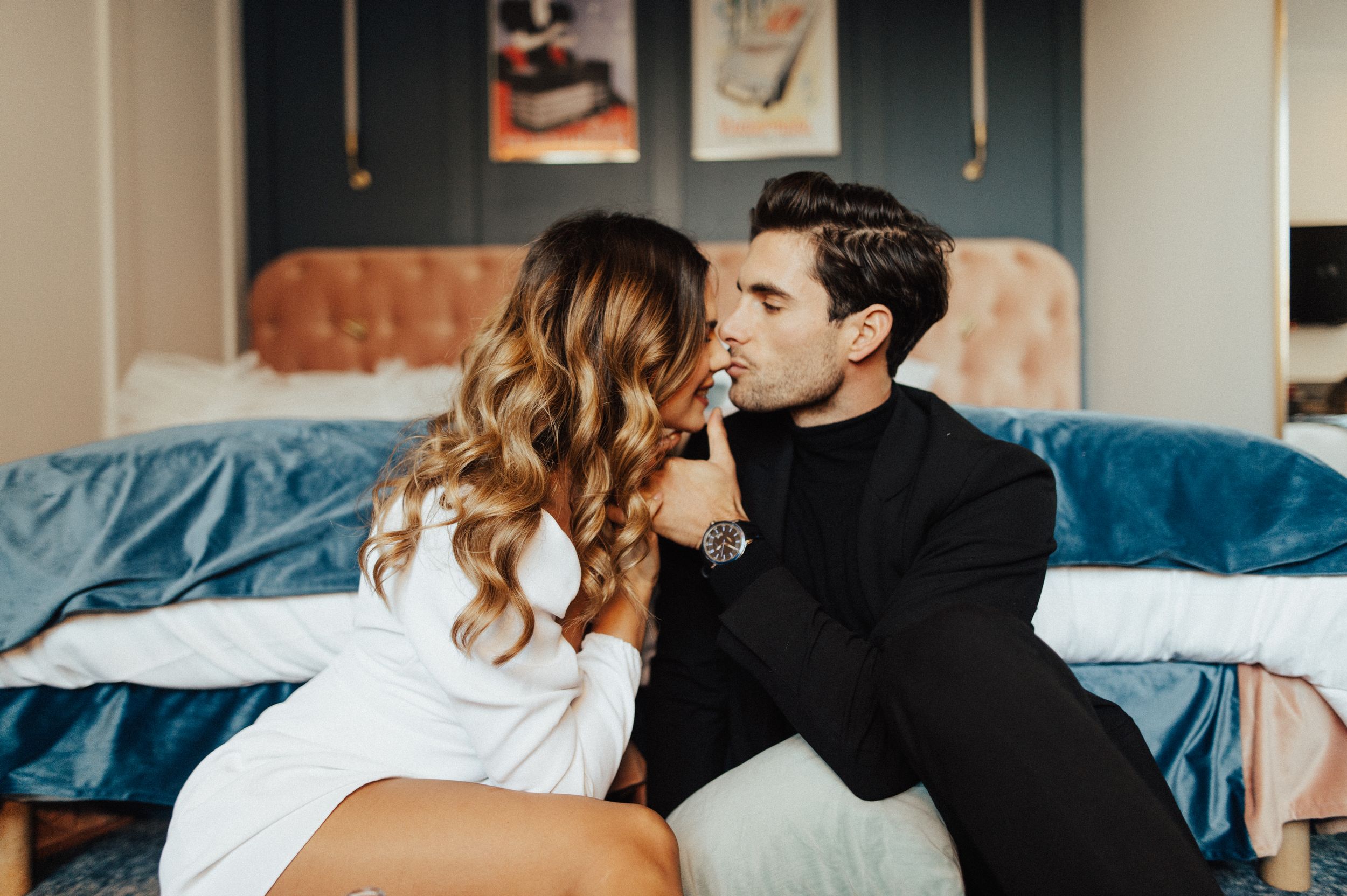 Intimate lifestyle photography of couple in contemporary bedroom setting.
