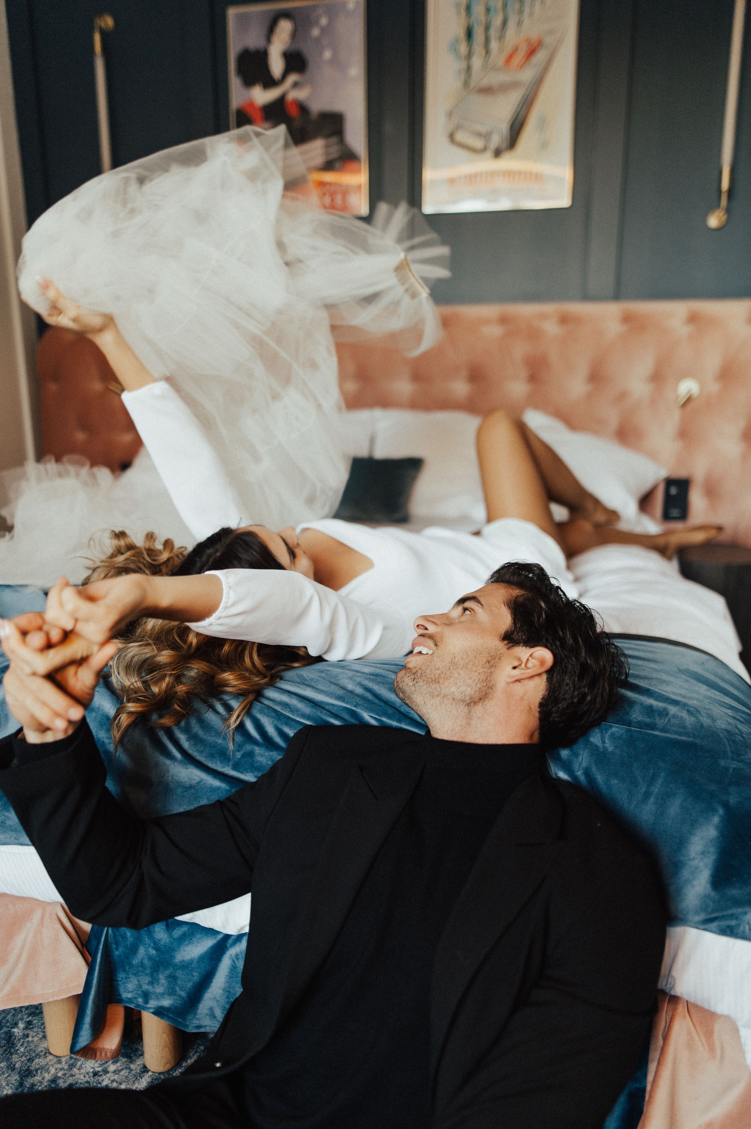 A series of artistic boudoir photos showing someone lying on blue bedding with white tulle fabric.