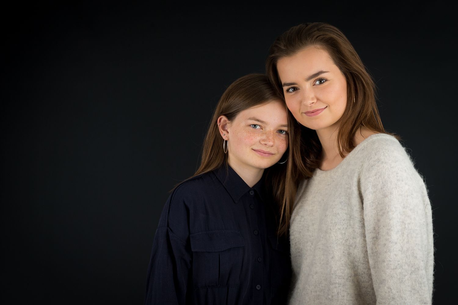 Intimate portrait series against a dark studio background.